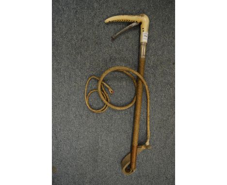 An unusual riding whip by Swaine &amp; Adeney with silver collar, the stag antler handle incorporating a wire cutter.