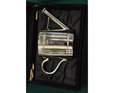 A novelty watering can shaped tea light holder.