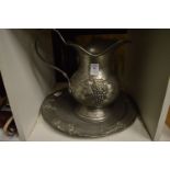 A pewter jug and dish.