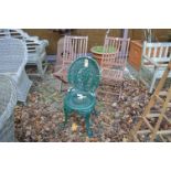 A pair of folding wooden chairs and a green painted aluminium chair.