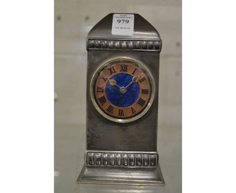 Liberty &amp; Co, a Tudric mantel clock, no. 01034 with copper chapter ring, enamel decoration to the centre, 18cm high.