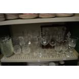 A quantity of glassware to include decanters, jugs, tantalus with mixed decanters and other items.