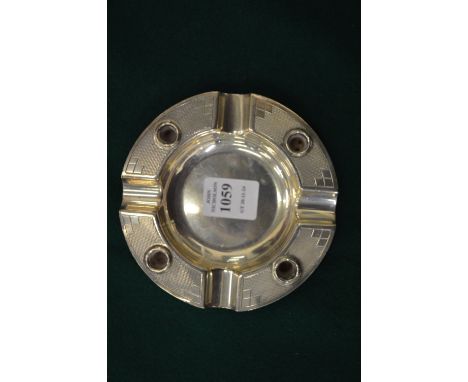 An unusual silver ash tray with engine turned decoration.