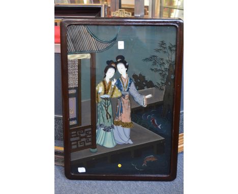 A Chinese reverse painting on glass depicting two female figures by a building.