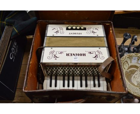 A boxed Hohner Student accordian.