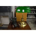 A brass desk lamp and a model traction engine.