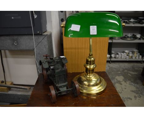 A brass desk lamp and a model traction engine.