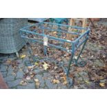 A green painted wrought iron table base.