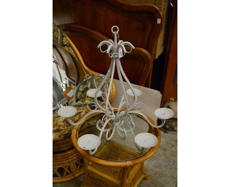 A white painted wrought iron candle chandelier.