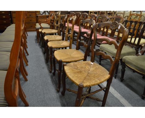 Six French elm and rush seated ladder back dining chairs.