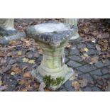 A reconstituted stone pedestal.