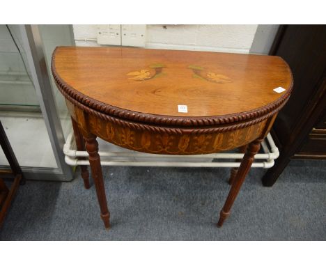 An inlaid mahogany demi-lune fold-over card table.