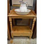 A pine washstand with jug and bowl.