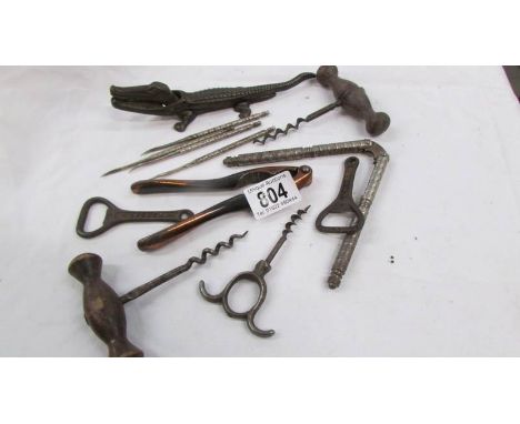 A vintage cast iron crocodile nut cracker, cork screws and bottle openers.