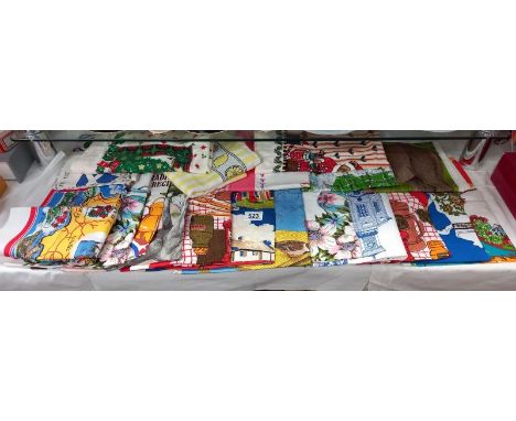 A quantity of vintage tourist tea towels.