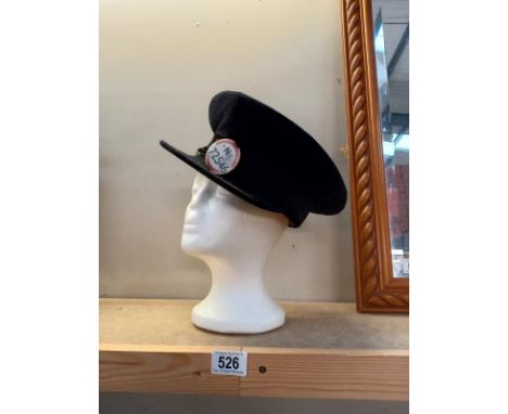A vintage bus driver cap with badge.