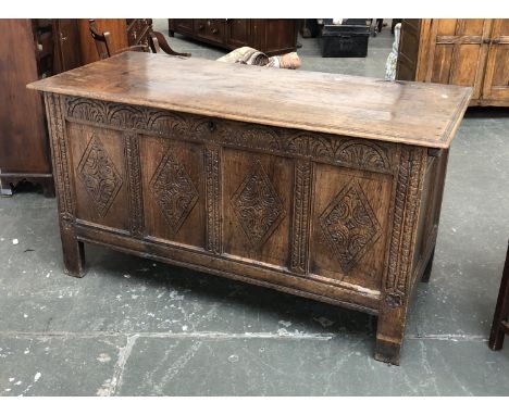 A 17th/early 18th century four panel oak coffer, with later demilune carving, over four lozenge carved panels, 152x65x81cmH 