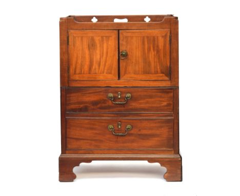 A George III mahogany tray top commode, the gallery with pierced handles and quatrefoils, over cupboard doors and pull out co