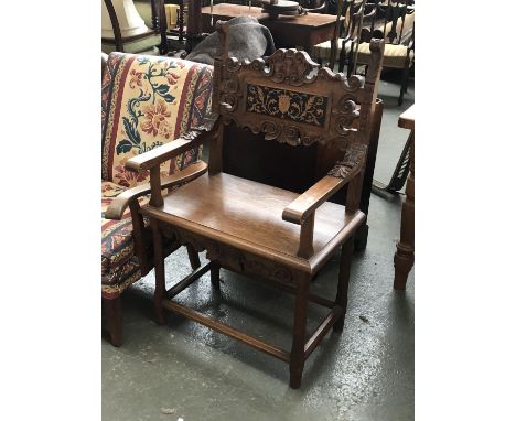 A carved oak throne chair, the back with central inlaid panel, 65cmW 