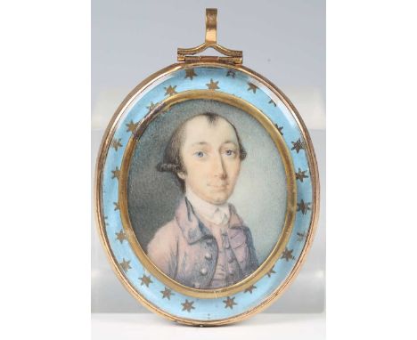 British School - a late 18th century watercolour portrait miniature on ivory depicting a young gentleman wearing a mauve jack