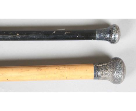 A 19th century Malacca walking cane with foliate chased silver pommel, length 92cm, together with an ebonized walking stick w