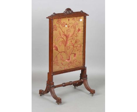 A late Victorian walnut framed firescreen, inset with a pink floral silkwork panel, height 112cm, width 59cm.