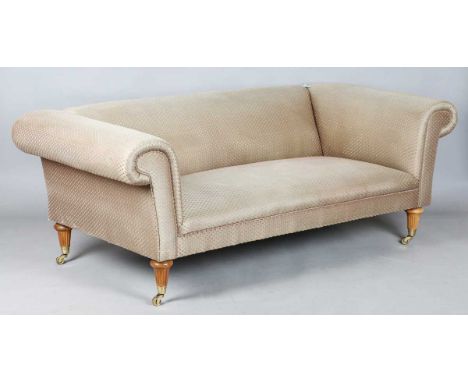 A David Linley scroll arm sofa, upholstered in pink dotted gilt damask, raised on fluted wooden legs with brass caps and cast