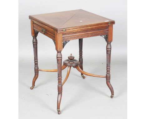 An Edwardian mahogany envelope card table, raised on spiral fluted legs and castors, height 73.5cm, width 56cm.