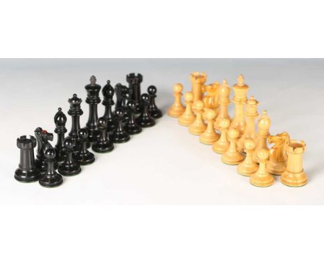 An early 20th century boxwood and ebony Staunton chess set with weighted bases, the knights and castles bearing red crowns, h