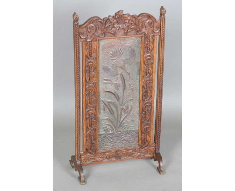 A late Victorian Arts and Crafts oak framed and copper inset firescreen, the panel worked with bulrushes, bird and dragonfly,