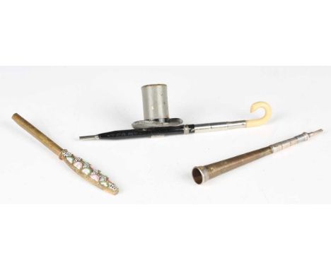 An early 20th century novelty dip pen in the form of an umbrella and top hat, length 11.5cm, together with a propelling penci