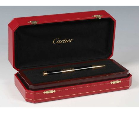 A Cartier limited edition perpetual calendar ballpoint pen, the finial inset with glazed timepiece, the shaft with turning ca