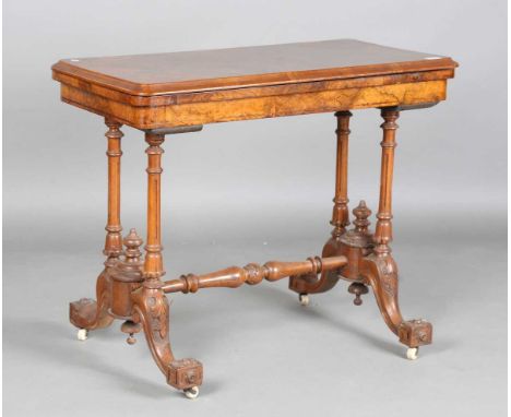 A mid-Victorian burr walnut rectangular fold-over card table, raised on fluted legs and carved feet, height 74cm, width 92cm,