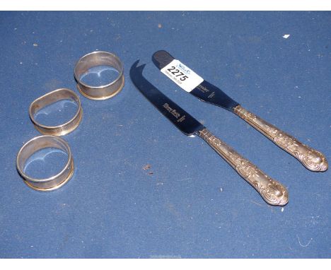 A small quantity of silver including three silver napkin rings, Birmingham, and silver handled butter and cheese knives, Shef