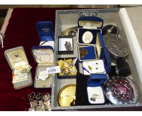 A box of brooches, a silver and amber pendant and earring set, Vogue compact, Swarovski trinket box, etc.