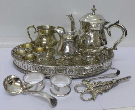 Two silver napkin rings, 29g, a three piece plated tea service and tray, etc.