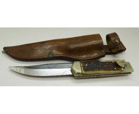 A hunting knife with antler handle and scabbard