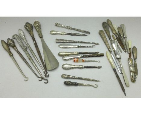 A collection of silver handled manicures, button hooks and a shoe horn, etc.