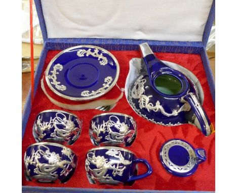 A Chinese tea service with applied white metal dragon decoration, boxed