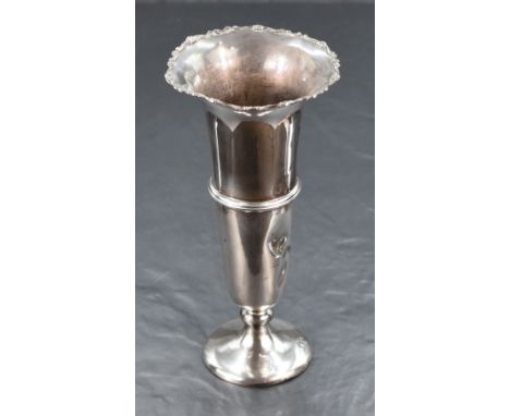 A George V silver fluted vase, having a flared rim with scroll decoration, a central moulded step band raised on a knopped st
