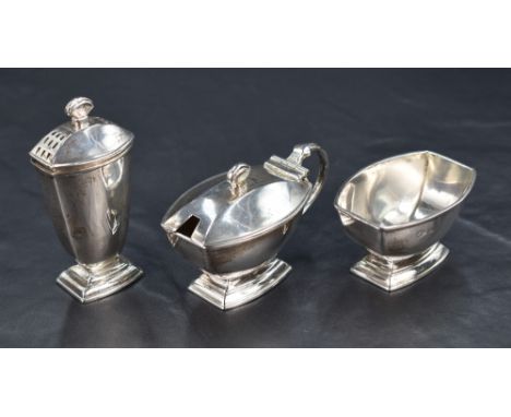 A George V silver three-piece condiment set, comprising salt, pepperette and mustard, of rounded rectangular form, raised on 
