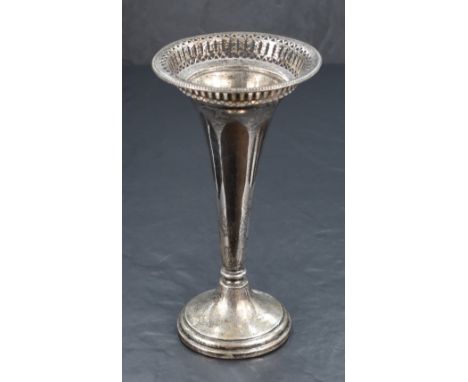 An early George V silver vase, of fluted form with decorative pierced rim with bead thread, raised on a knopped stem and circ