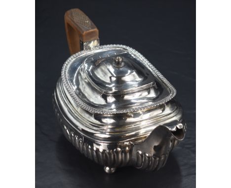 A George III silver tea pot, of squat rounded rectangular form, having slightly flared egg and dart style rim, moulded step d