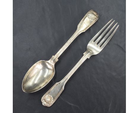 An early 19th century silver fiddle shell and thread pattern spoon and fork, having engraved heraldic crest, marks for London