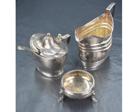 A group of 18th/19th century silver table accoutrements, comprising a milk jug of oval form with moulded step decoration and 