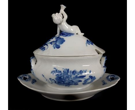 An unusual Royal Copenhagen porcelain sauce tureen and cover with integral stand, the cover with putti playing a trumpet fini