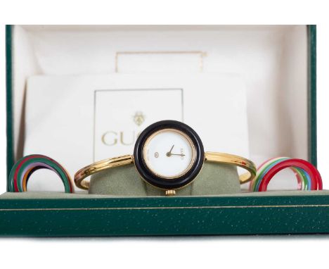 GUCCI GOLD PLATED QUARTZ WRIST WATCH  the round white dial lacking numerals, with interchangeable coloured bezels, the 26mm c