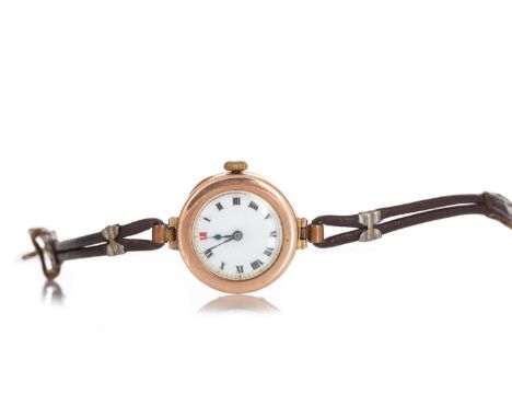 LADY'S WRIST WATCH NINE CARAT GOLD MANUAL WIND the round white dial with Roman hour markers, 24mm case, on a brown leather st