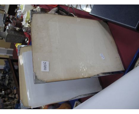 A Pair of Art Deco Free Standing Photograph Frames, with angular chrome corner mounts, 36cm high x 25.5cm wide.