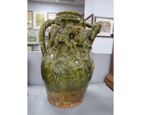 Studio Terracota Pottery Green Glaze Ewer, with entwined handle and four raised Knights on Horseback, 37cm high (chipped).